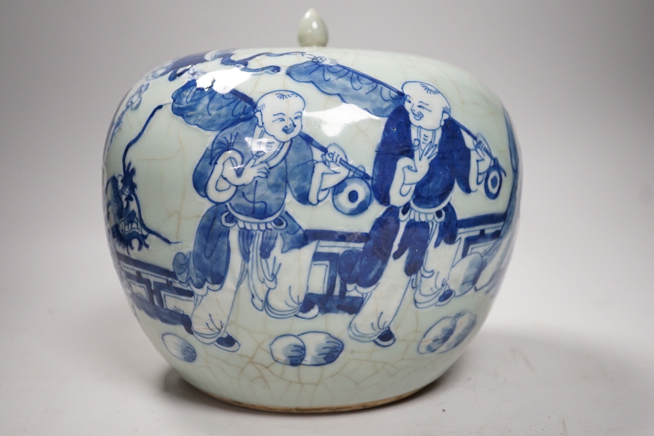 A Chinese underglaze blue and slip decorated celadon crackle glazed vase and associated cover, late Qing dynasty, 21cms high